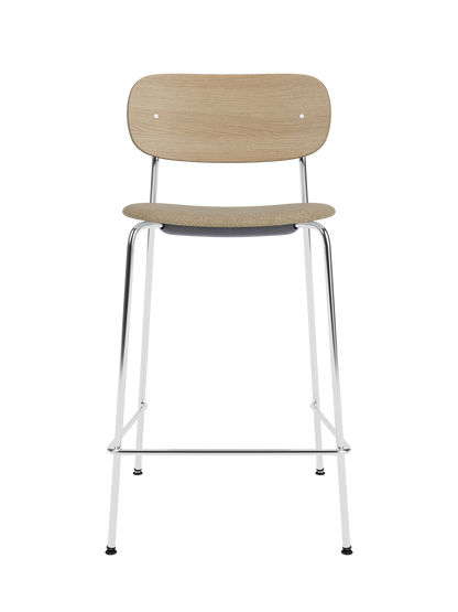 Co Counter Chair in natural oak with a chrome frame and bouclé upholstered seat.