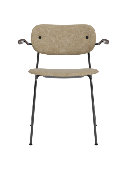 Fully upholstered Co Dining Chair with armrests, featuring beige bouclé fabric and dark stained oak on a black frame.