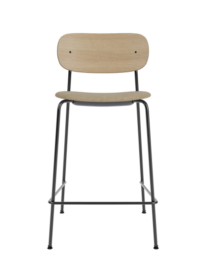 Co Counter Chair, Seat Upholstered in beige Audo Bouclé 02 with a curved natural oak back and slender black steel frame.