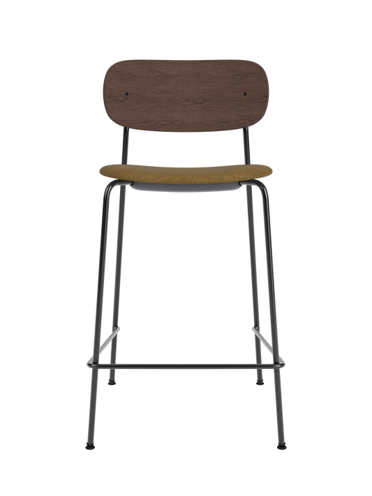 Co Counter Chair with a dark stained oak backrest and mustard bouclé upholstered seat on a slender black steel frame.