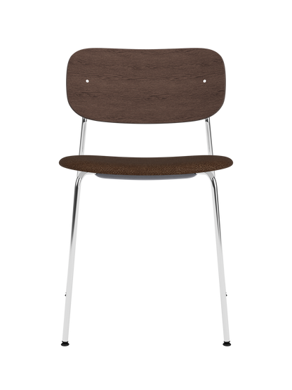 Co Dining Chair with chrome frame, dark stained oak backrest and dark bouclé upholstered seat on a white background.