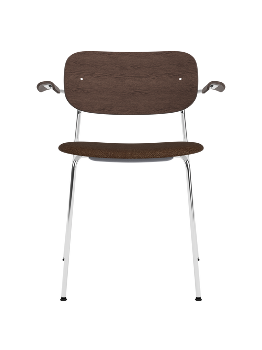 Co Dining Chair with armrests, featuring a chrome frame, dark stained oak backrest and brown bouclé upholstered seat.