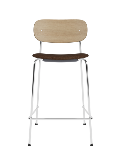 Co Counter Chair with a natural oak wood back, brown bouclé upholstered seat, and a chrome steel frame.