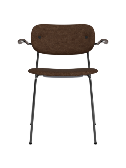 Co Dining Chair with armrests, upholstered in dark Audo Bouclé 07 with dark stained oak details and black frame.
