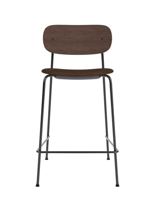 Co Counter Chair with dark stained oak back and brown bouclé upholstered seat on a slender black metal frame.