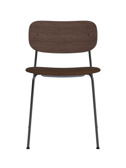 Co Dining Chair featuring a black steel frame, curved dark stained oak backrest and brown bouclé upholstered seat.