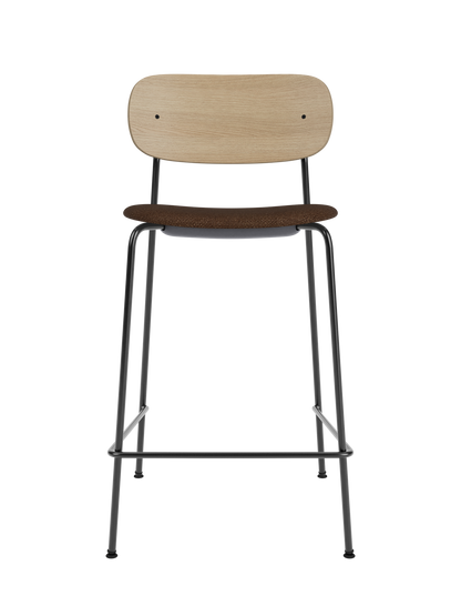 Co Counter Chair featuring a natural oak back, black bouclé upholstered seat and a slim black steel frame.