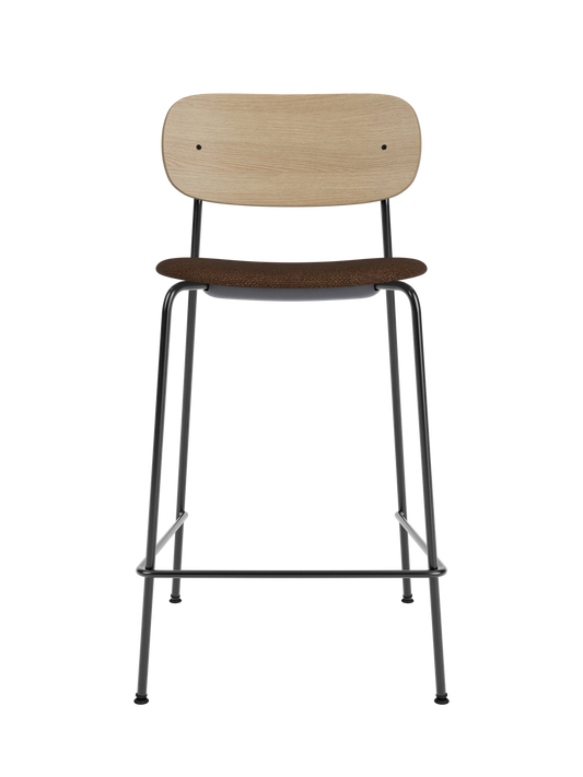 Co Counter Chair featuring a natural oak back, black bouclé upholstered seat and a slim black steel frame.