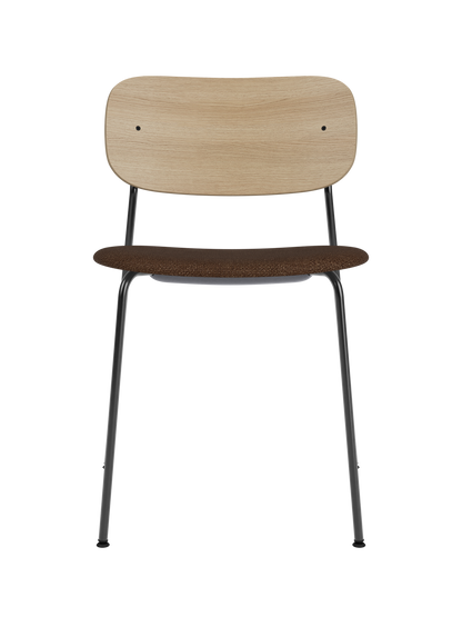 Co Dining Chair featuring a black steel frame, a natural oak backrest, and a brown bouclé upholstered seat.