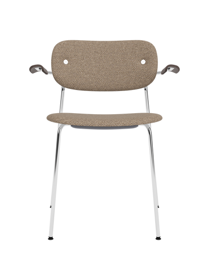 Fully upholstered Co Dining Chair with a chrome frame, dark stained oak armrests and textured Logan Flint fabric.