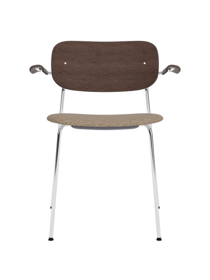 Co Dining Chair with chrome armrest frame, dark stained oak backrest, and beige Logan Flint upholstered seat.
