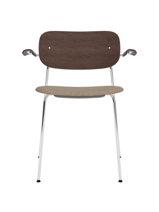 Co Dining Chair with chrome armrest frame, dark stained oak backrest, and beige Logan Flint upholstered seat.
