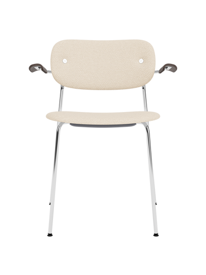 Co Dining Chair with armrests, featuring Logan Jasmine upholstery, dark stained oak armrests and a chrome frame.