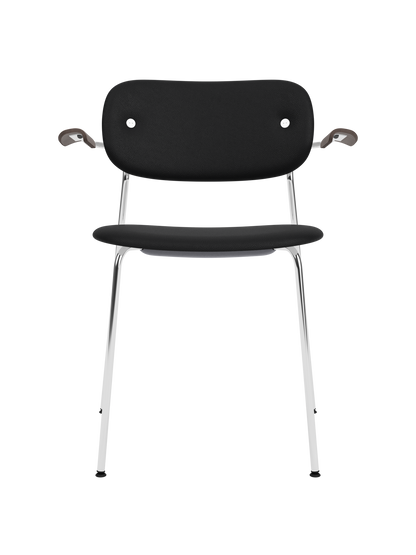 Fully upholstered Co Dining Chair with black Sierra leather, a chrome frame and dark stained oak armrests.