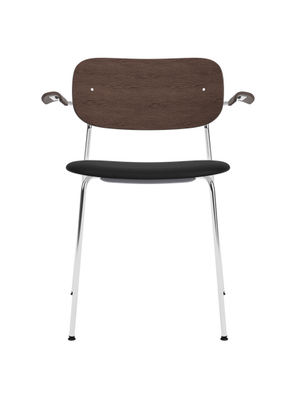 Co Dining Chair with armrests, featuring a chrome frame, dark stained oak back and black leather upholstered seat.