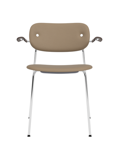 Fully upholstered Co Dining Chair with chrome frame, dark stained oak armrests and tan Sierra 1611 leather.