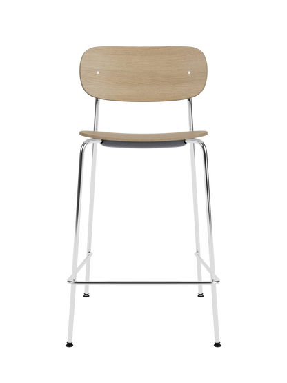 Co Counter Chair in natural oak veneer with a chrome steel frame shown against a solid black background.