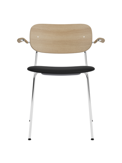 Co Dining Chair with a chrome frame, natural oak backrest and armrests, and a black Sierra leather upholstered seat.