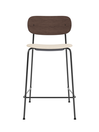 Co Counter Chair with a dark stained oak back and Logan Jasmine upholstered seat on a black powder-coated frame.