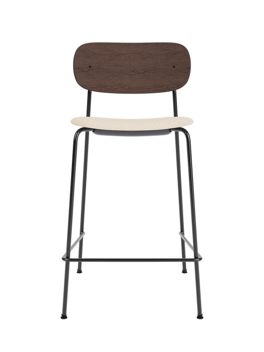 Co Counter Chair with a dark stained oak back and Logan Jasmine upholstered seat on a black powder-coated frame.