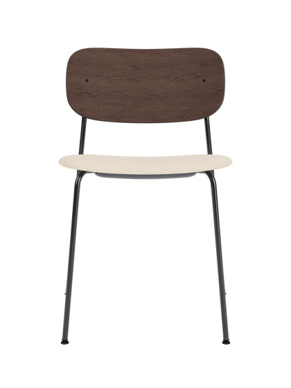 Co Dining Chair featuring a dark stained oak backrest and Logan Jasmin upholstered seat on a slim black metal frame.
