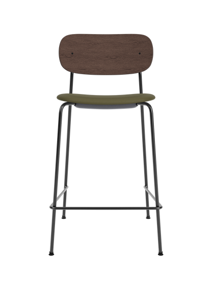 Co Counter Chair featuring a dark stained oak backrest, green Sierra 0441 upholstered seat, and black steel frame.