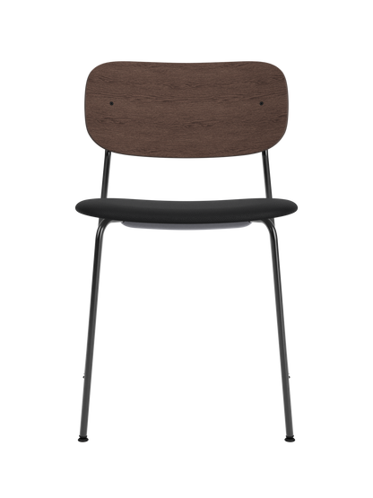 Co Dining Chair featuring a black steel frame, dark stained oak backrest, and black Sierra leather upholstered seat.