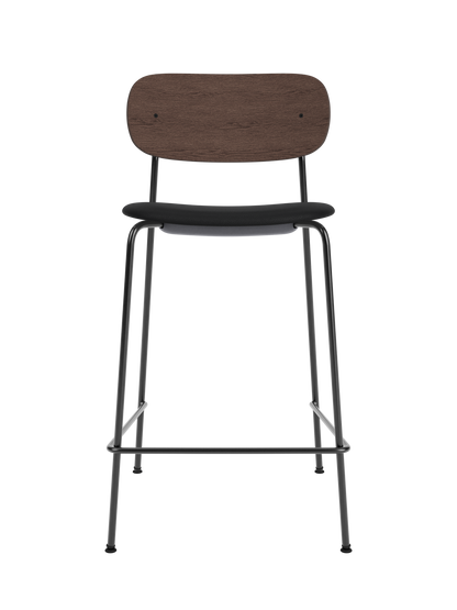 Co Counter Chair featuring a black upholstered seat, dark-stained oak backrest and slender black steel frame.