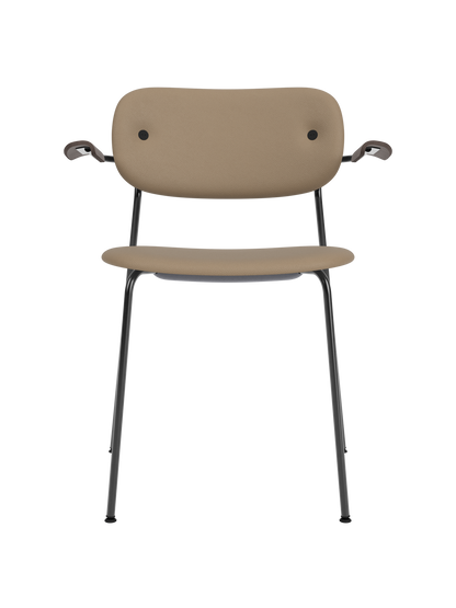 Co Dining Chair, fully upholstered in tan Sierra leather with dark stained oak armrests and black steel frame.