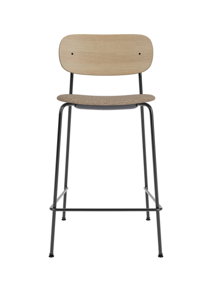 Co Counter Chair with a natural oak back and Logan Flint upholstered seat on a slim black powder-coated steel frame.