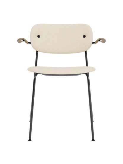 Co Dining Chair with armrests in beige Logan Jasmine upholstery, natural oak and a black powder-coated steel frame.