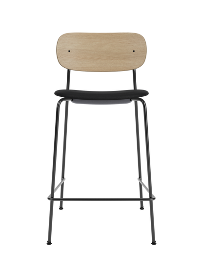 Co Counter Chair featuring a natural oak backrest, black upholstered seat and slender black steel frame.