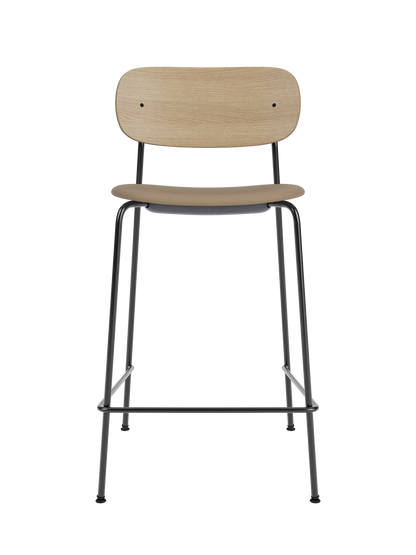Co Counter Chair featuring a natural oak back and tan Sierra 1611 upholstered seat on a black steel frame.