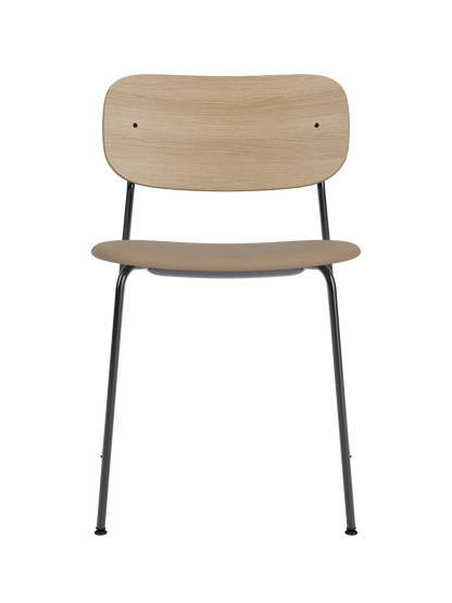 Black-framed Co Dining Chair with a natural oak backrest and beige Sierra leather upholstered seat.