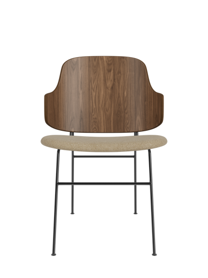 The Penguin Dining Chair with a curved walnut back and beige Audo Bouclé seat on a slender black steel frame.