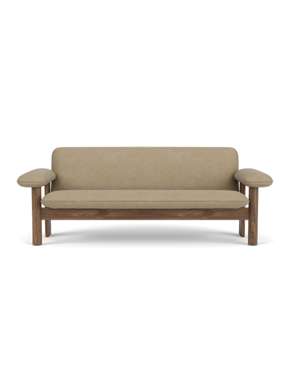 A front-on studio shot of the Brasilia Sofa, featuring a walnut wood frame and beige Audo Bouclé 02 upholstery.