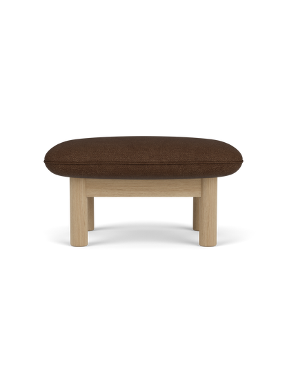 Side profile of the Brasilia Ottoman, upholstered in brown bouclé fabric with a natural oak frame and four cylindrical legs.