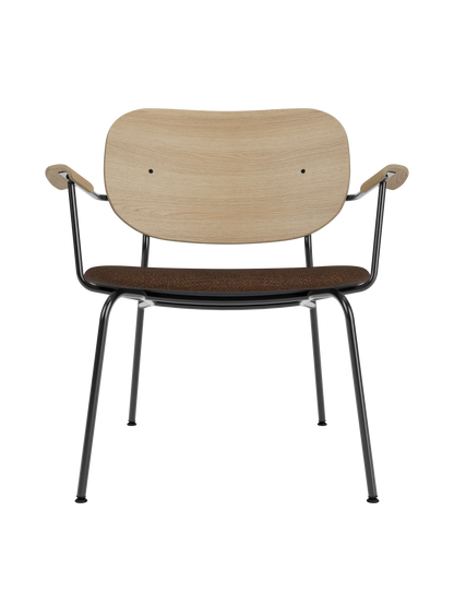 Co Lounge Chair with natural oak backrest and brown bouclé upholstered seat on a slim black powder-coated steel frame.