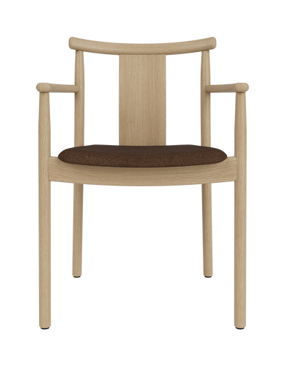 Natural oak Merkur Dining Chair with Armrests featuring a textured dark brown Audo Bouclé 07 upholstered seat.