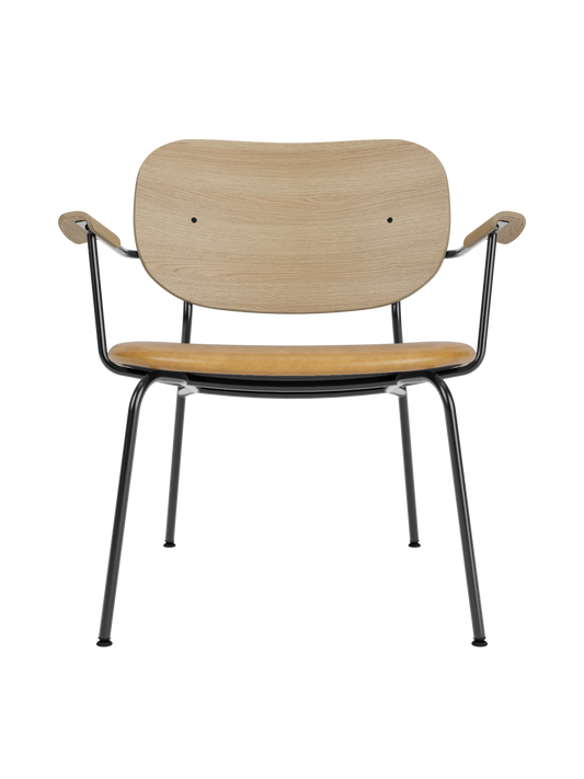 Co Lounge Chair in natural oak with a tan Dakar 0250 leather seat and a slender black powder-coated steel frame.