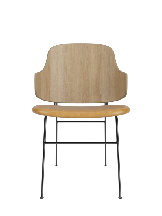The Penguin Dining Chair with a natural oak back and tan upholstered seat on a slender black steel frame.