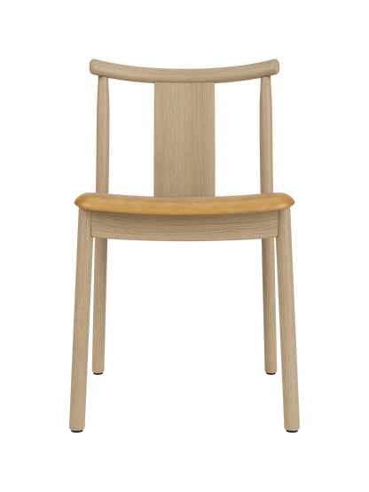 Merkur Dining Chair in natural oak with a tan upholstered seat, featuring a modern solid wood frame and curved backrest.