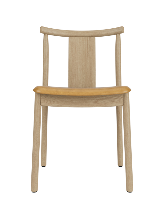 Merkur Dining Chair in natural oak with a tan upholstered seat, featuring a modern solid wood frame and curved backrest.