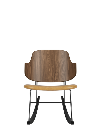 The Penguin Rocking Chair featuring a curved walnut back, tan upholstered seat and black steel frame with ash rockers.
