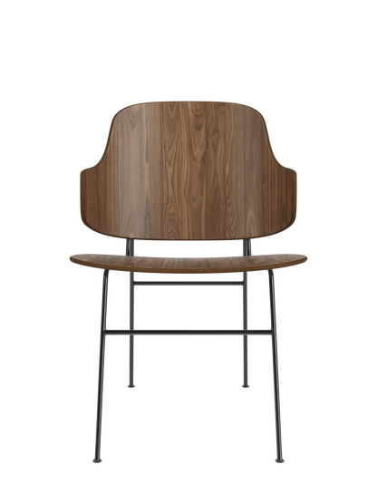 The Penguin Dining Chair in walnut veneer with a sculptural penguin-shaped back and a slender black steel frame.