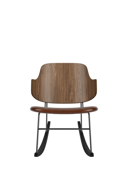 The Penguin Rocking Chair with a walnut veneer back and brown upholstered seat on a black steel frame and rockers.