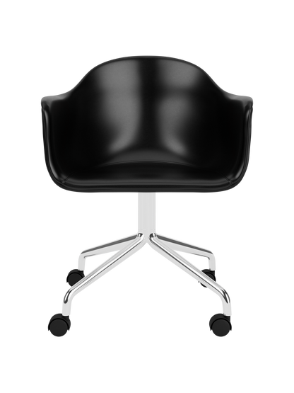 Black leather Harbour Dining Chair featuring a polished aluminium star base with castors against a white background.