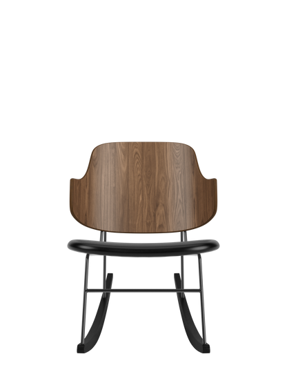 The Penguin Rocking Chair with a curved walnut back, black leather upholstered seat and a minimalist black steel frame.