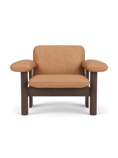 Front view of the Brasilia Lounge Chair, Low Back, featuring a dark stained oak frame and camel leather upholstery.