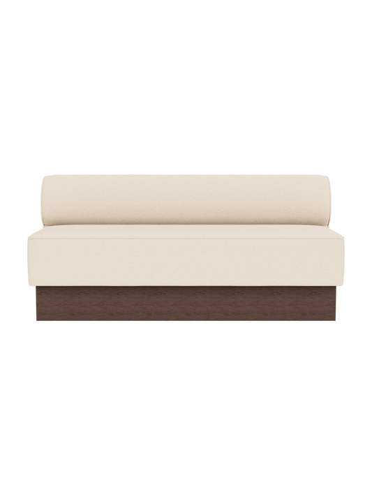 The Eave Dining Sofa, Plateau in Logan Jasmine upholstery with a dark stained oak base, shown from the front.